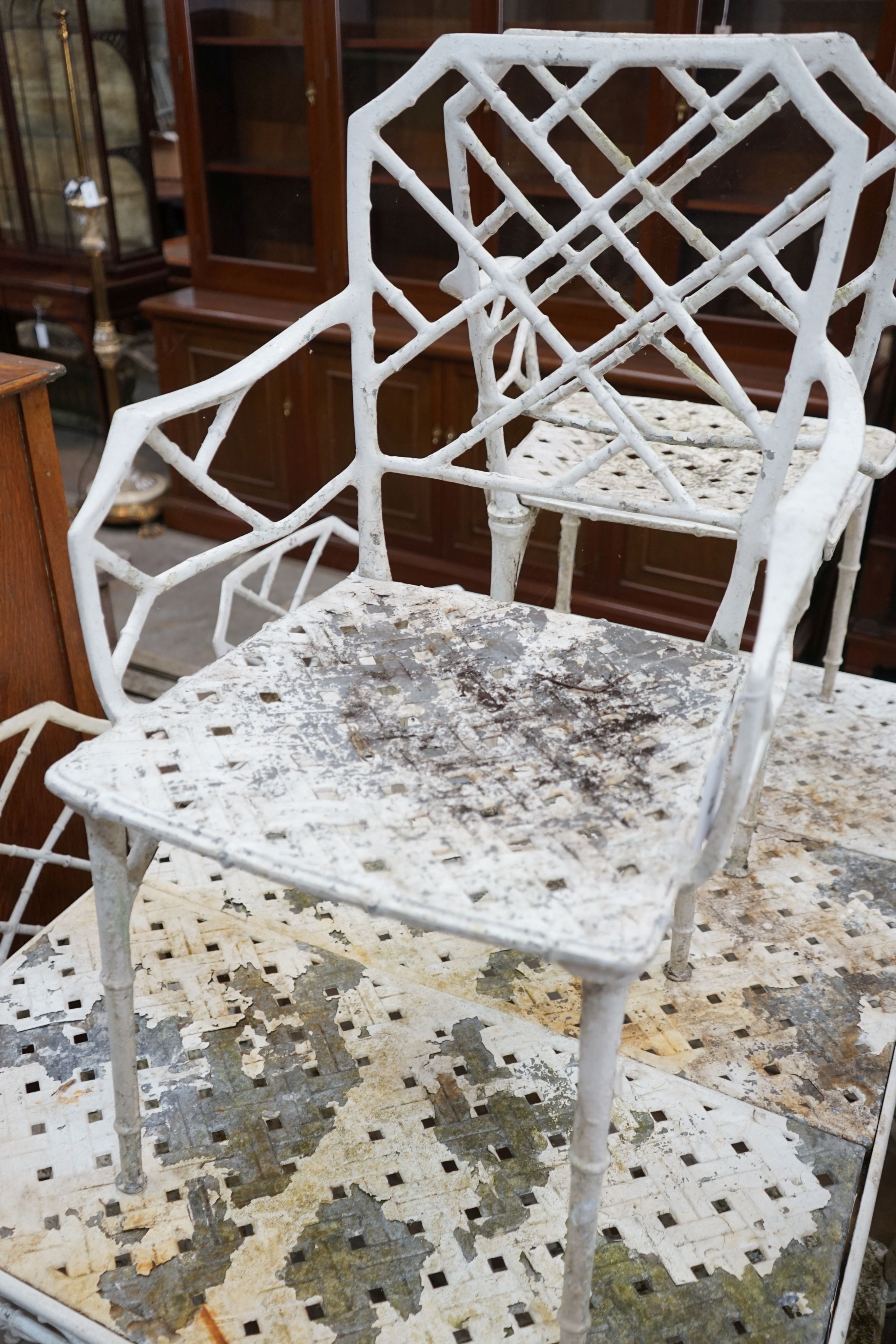 A painted aluminium faux bamboo rectangular garden table, width 130cm, depth 89cm, height 72cm and six chairs, two with arms